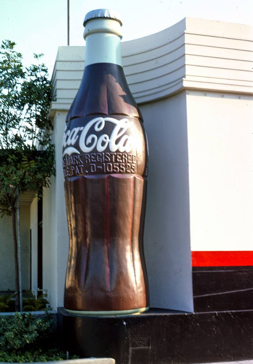 Historic Photo : 1977 Coca Cola Bottling Company, giant Coke bottle closer view, 14th & Central Avenue, Los Angeles, California | Photo by: John Margolies |