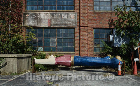 Photo- Giant roadside advertising figure, currently reclining and awaiting installation, outside the American Sign Museum in the industrial Camp Washington neighborhood of Cincinnati