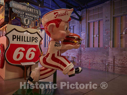 Photograph- A rescued Frisch's Big Boy advertising figure and an array of advertising signs inside the American Sign Museum in the industrial Camp Washington neighborhood of Cincinnati, Ohio
