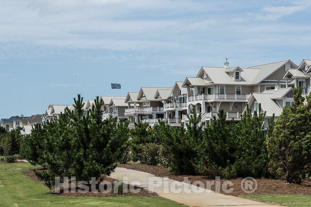 Photo- A long line of large beach condominiums or apartments in the town of Corolla in North Carolina's Outer Banks, a string of barrier splits and islands off the Atlantic Coast