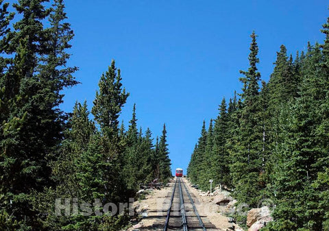 Photo- On the up and up (and up) for the Pikes Peak Cog Railway, which ascends Colorado's famous 14,115-foot Pikes Peak from its base station far below in Manitou Springs