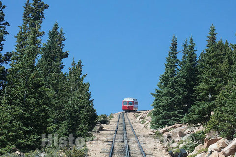 Photo- Both Coming and Going are steep for The Pikes Peak Cog Railway, which ascends Colorado's Famous 14,115-foot Pikes Peak from its Base Station far Below in Manitou Springs